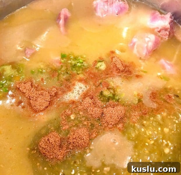 Add chili enchilada sauce, chili verde salsa, green peppers, and cumin