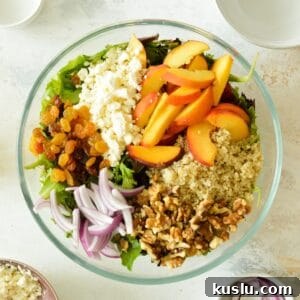 feta, peaches, raisins, quinoa, red onions, and mixed greens
