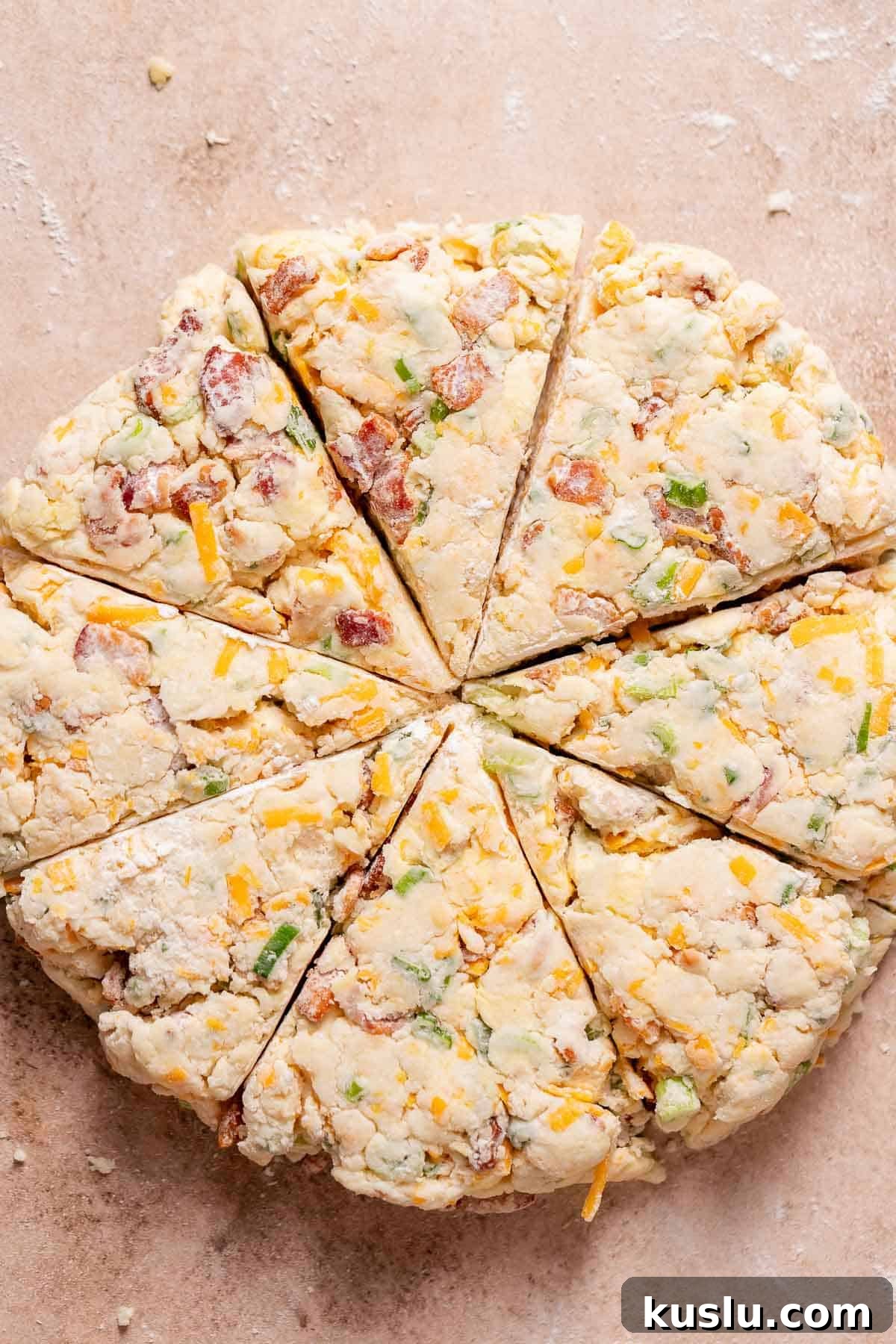 Bacon, Cheddar & Scallion Scones: Savory Breakfast Biscuits 8 An overhead shot of the scone dough cut into 8 triangles.