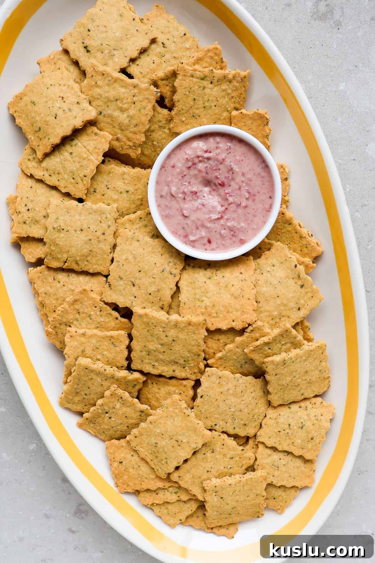 Close up of crackers on a platter with dip.