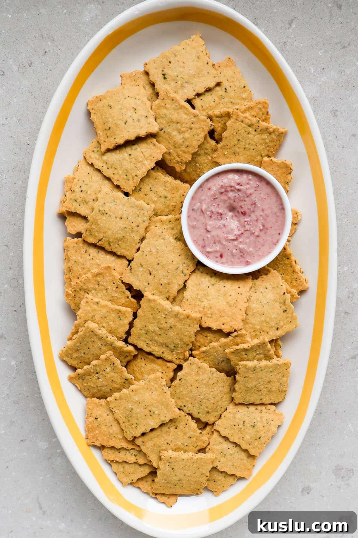 Chickpea crackers on a platter with dip.