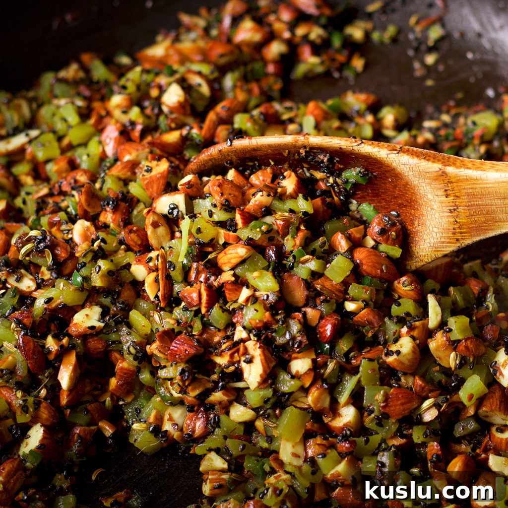 Almond and Roasted Green Chile Salsa Recipe 3 A photo showing all the ingredients for almond salsa in a skillet.