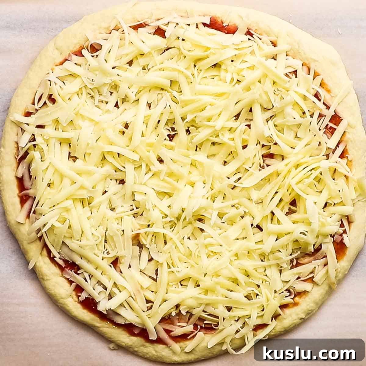 How to Make Thick Crust Pizza at Home: Crispy Edge, Chewy Center 15 grated cheese spread on top of the pizza