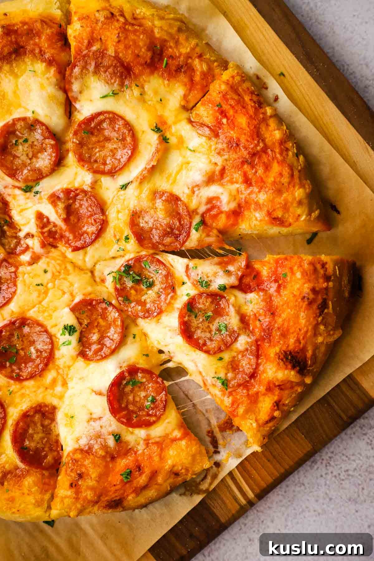 How to Make Thick Crust Pizza at Home: Crispy Edge, Chewy Center 3 overhead view of sliced thick crust pizza on a wooden board