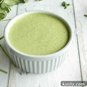 Cilantro Lime Crema: Creamy Sauce Recipe for Tacos & Bowls 10 cilantro lime crema in a bowl.