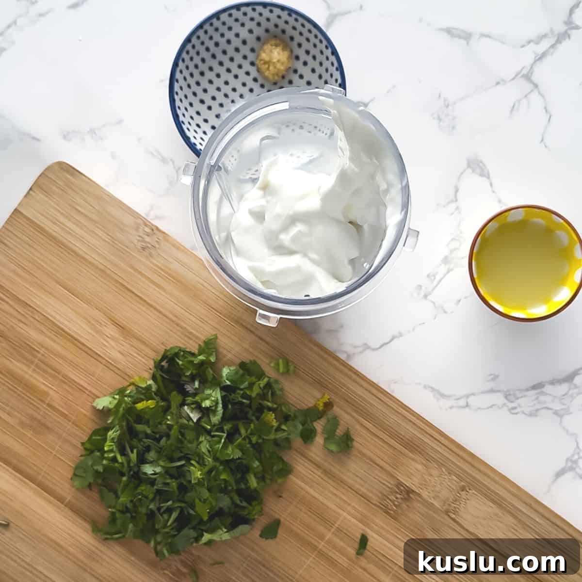 Cilantro Lime Crema: Creamy Sauce Recipe for Tacos & Bowls 4 Cilantro, lime juice, salt, garlic and Greek yogurt on a table.