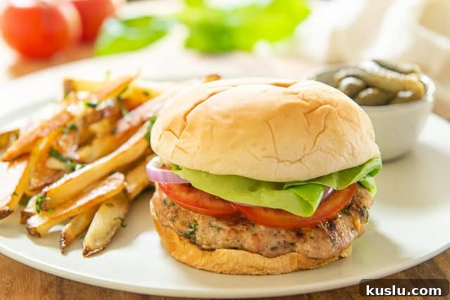 Turkey Burger Recipe - Served on Beige Plate with Pickles and Fries