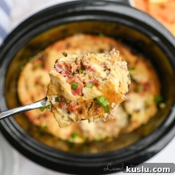 breakfast casserole on a spoon above a crock pot.