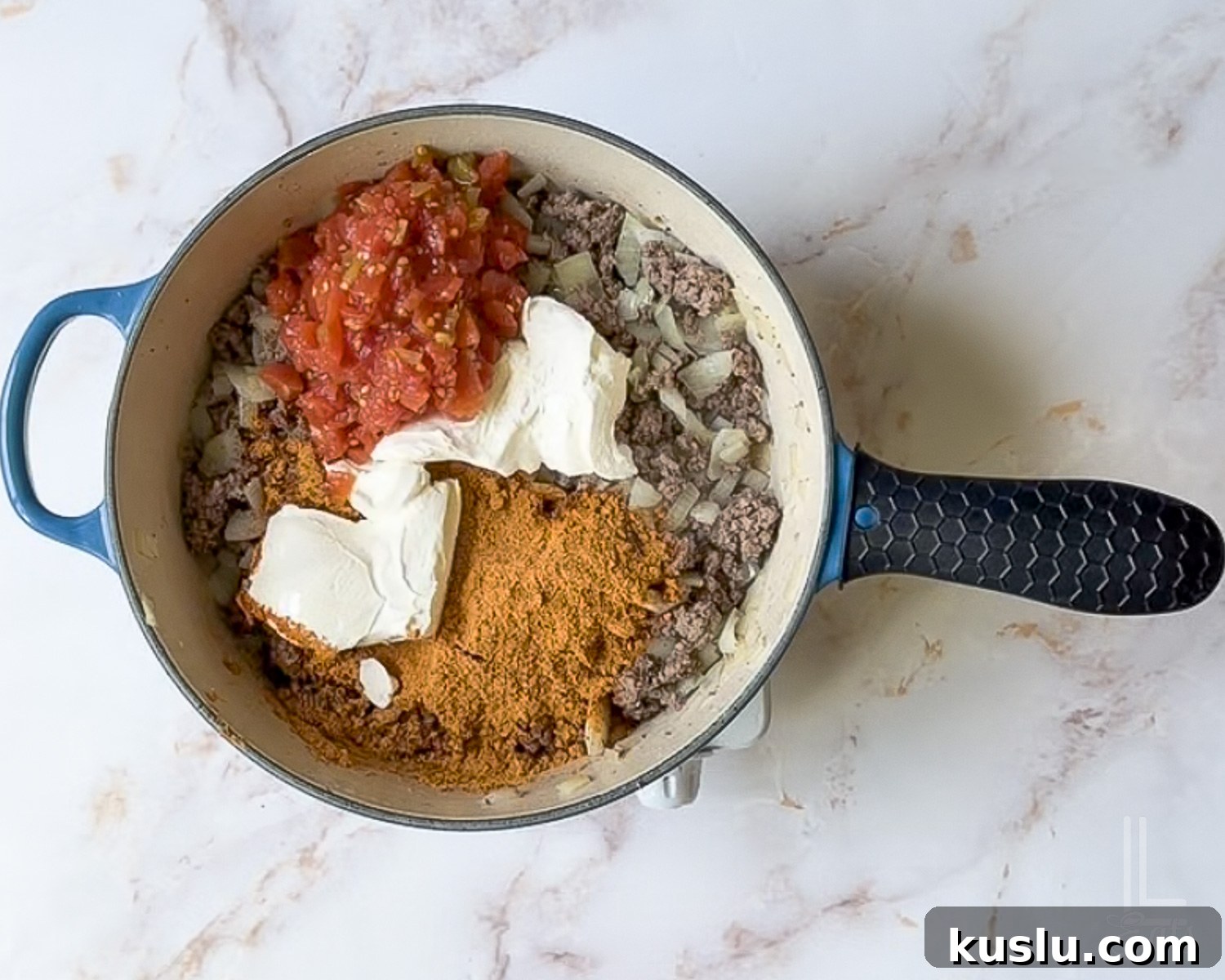 Walking Taco Casserole: Cheesy Taco Bake with Crunchy Nacho Topping 7 rotel, taco seasoning, and cream cheese added to the ground beef mixture.