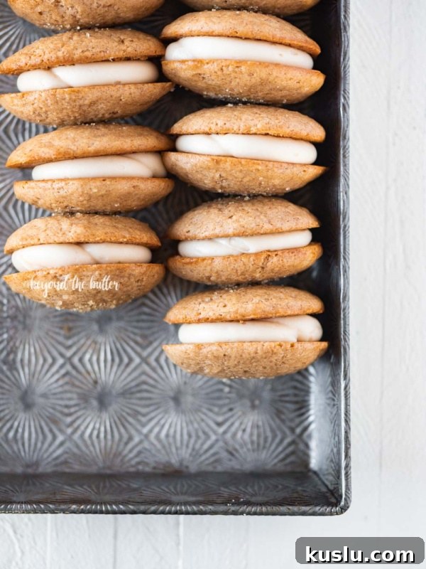Rows of apple cider whoopie pies in vintage baking pan.