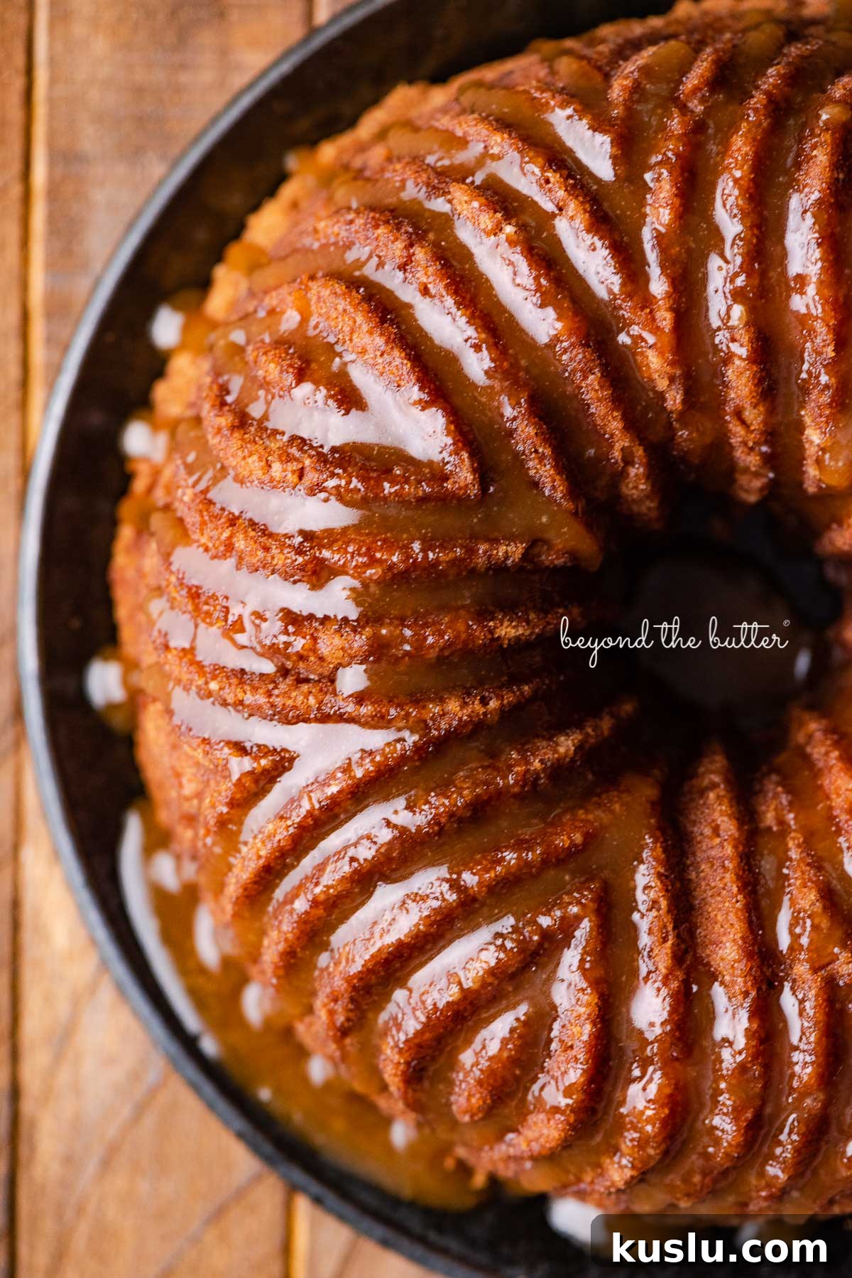 Apple bundt cake on black dessert plate | © Beyond the Butter®