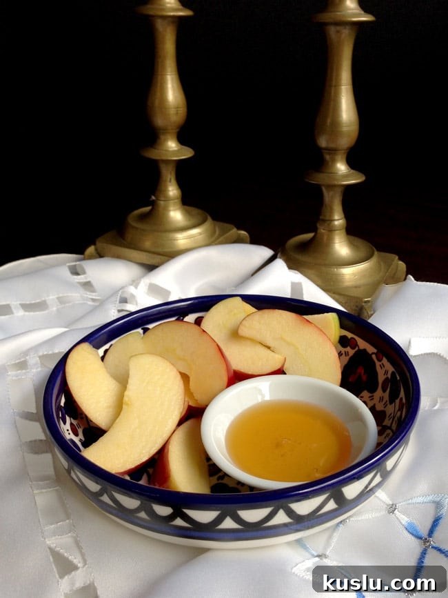Olive Oil Pear Cake with Ginger and Cinnamon Crumble 4 Apples and honey in a bowl with candlesticks in background