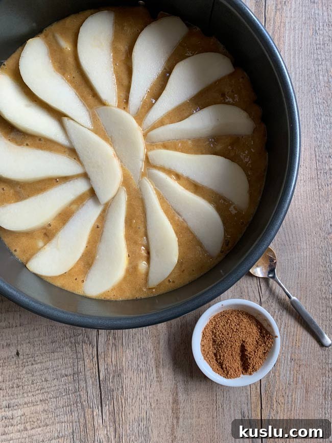 Olive Oil Pear Cake with Ginger and Cinnamon Crumble 7 Pear cake batter in round pan with cinnamon sugar, ready to go into the oven.