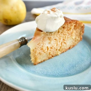 Olive Oil Pear Cake with Ginger and Cinnamon Crumble 10 close up cake slice with whipped cream fork on plate
