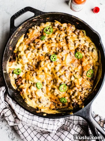 A cheesy bean dip in a skillet.