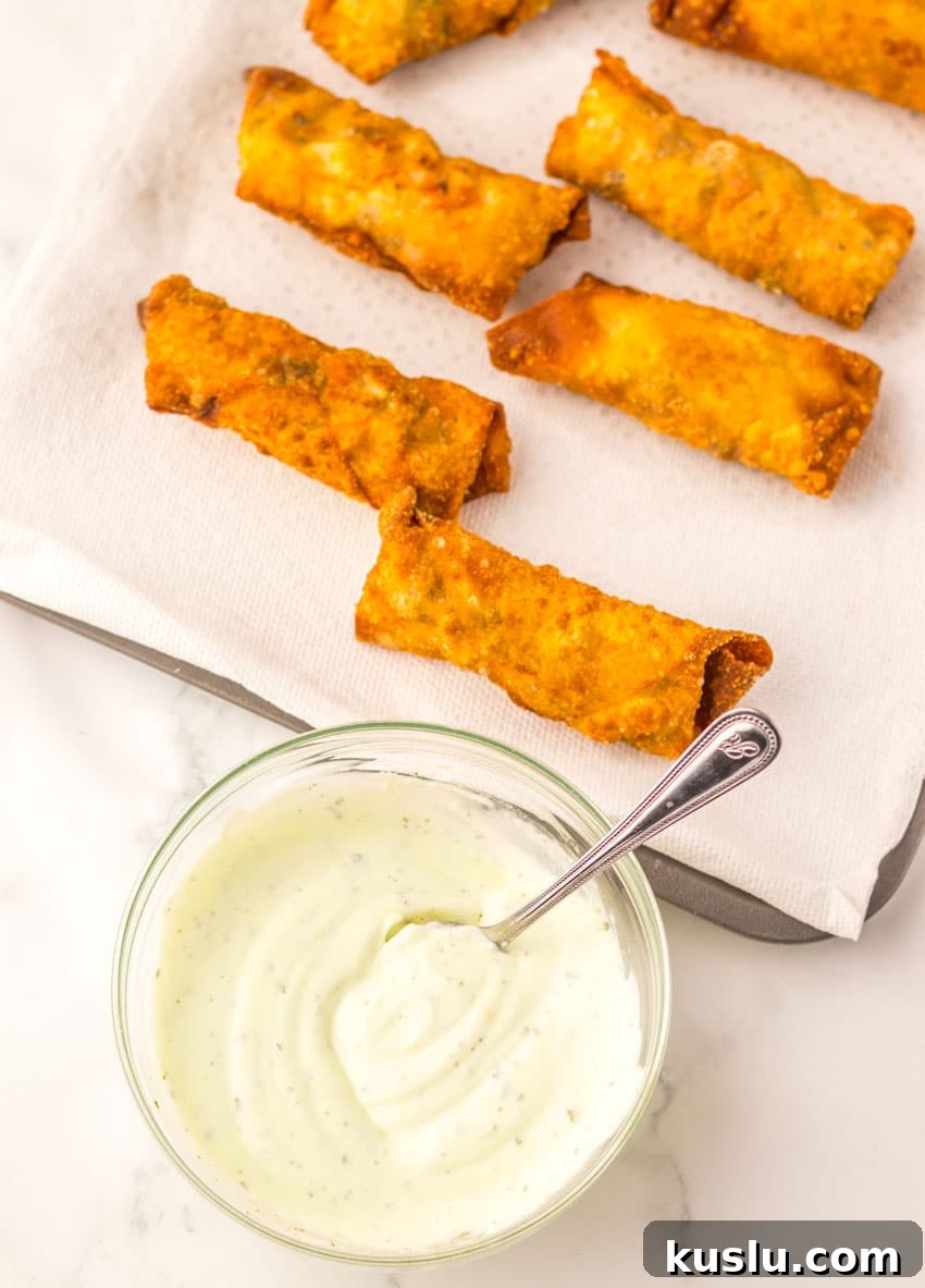 Southwestern Egg Rolls Copycat Recipe — Chili’s-Style Appetizer 6 fried egg rolls in two rows on a paper towel lined baking sheet