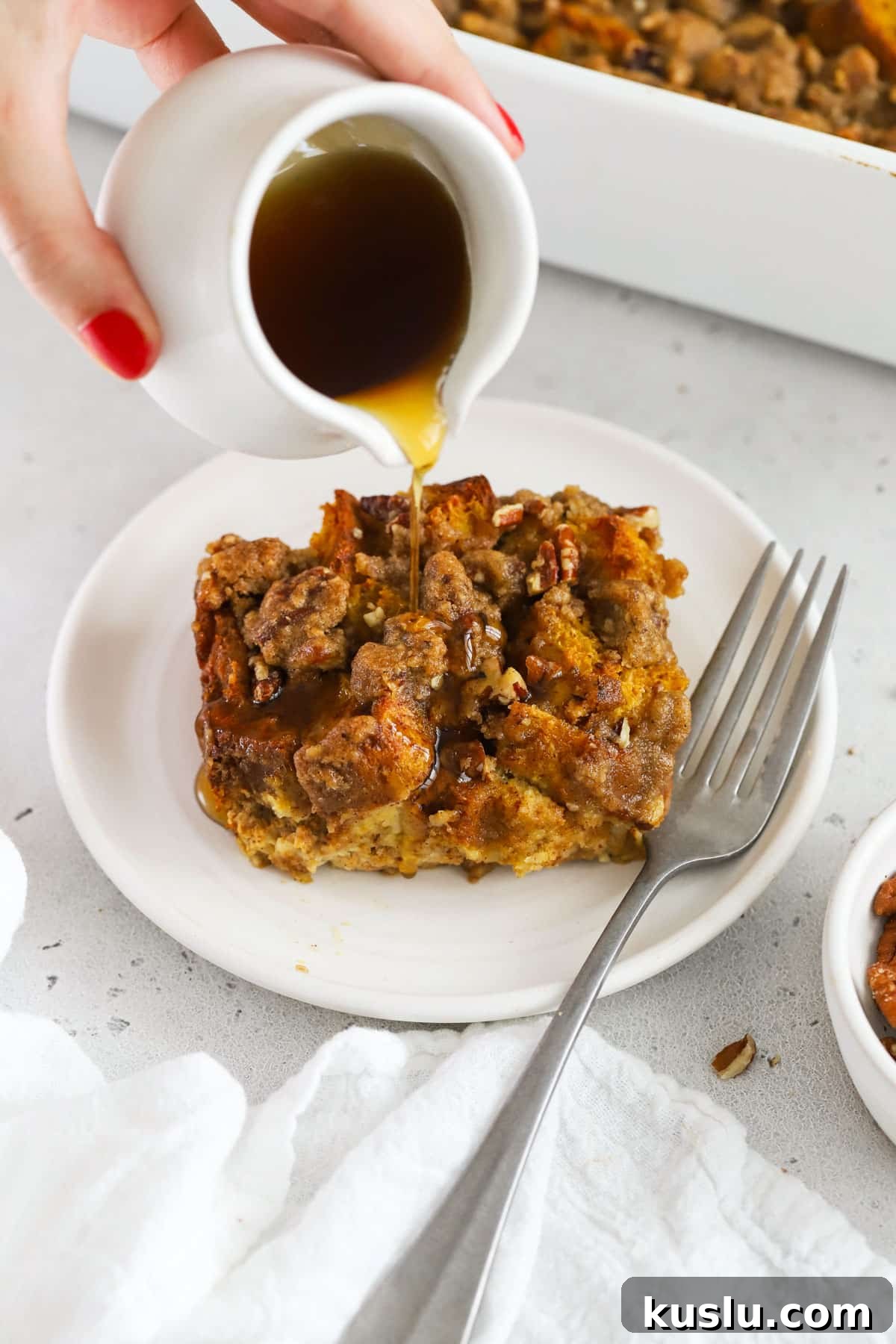Gluten-Free Pumpkin French Toast Casserole Recipe for Fall Brunch 2 Drizzling maple syrup over gluten-free pumpkin french toast casserole
