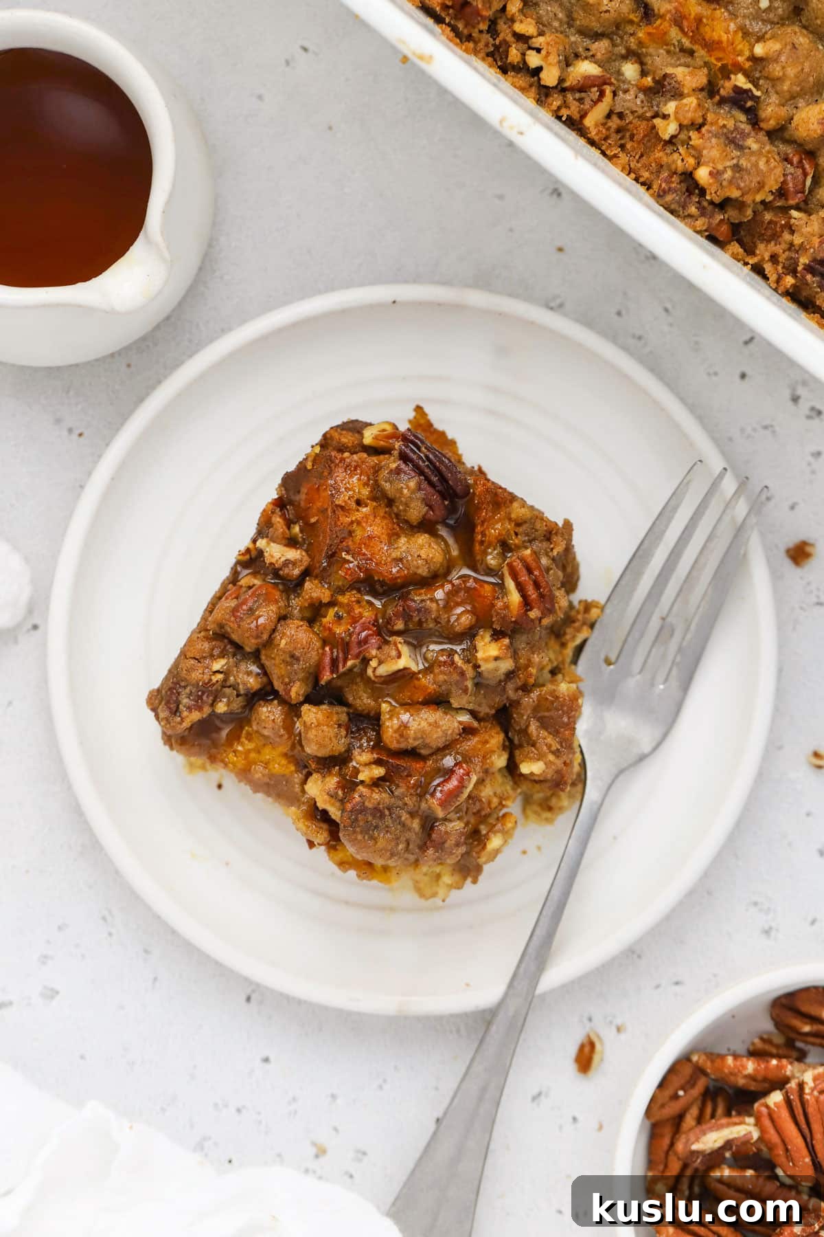 Gluten-Free Pumpkin French Toast Casserole Recipe for Fall Brunch 7 A plate of pumpkin french toast casserole drizzled with maple syrup