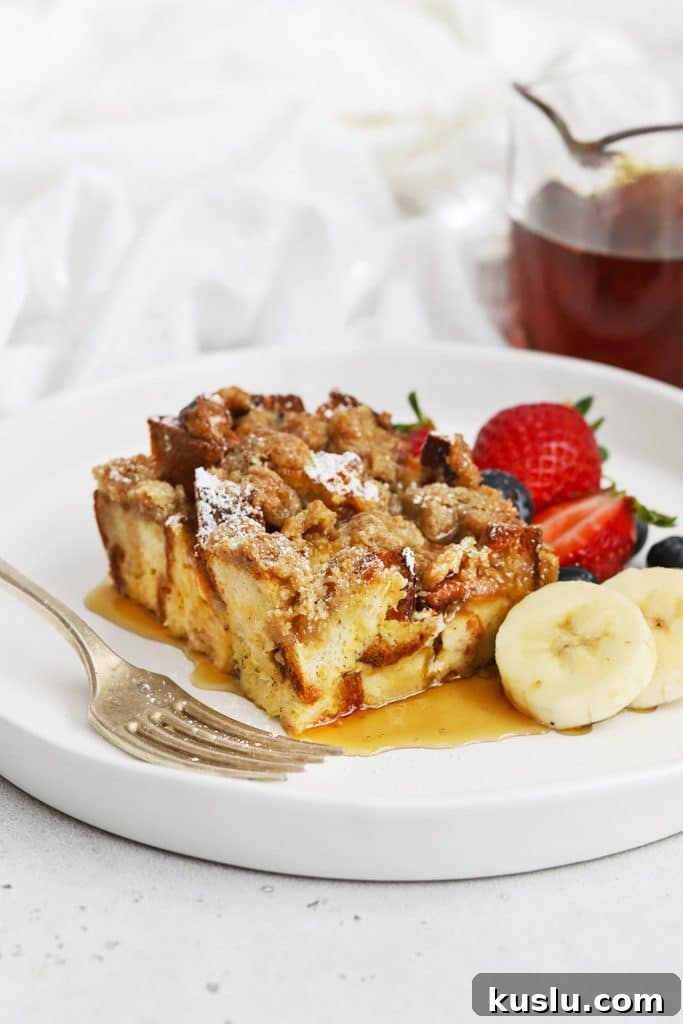 Gluten-Free Pumpkin French Toast Casserole Recipe for Fall Brunch 9 Front view of gluten-free eggnog french toast casserole topped with powdered sugar and maple syrup
