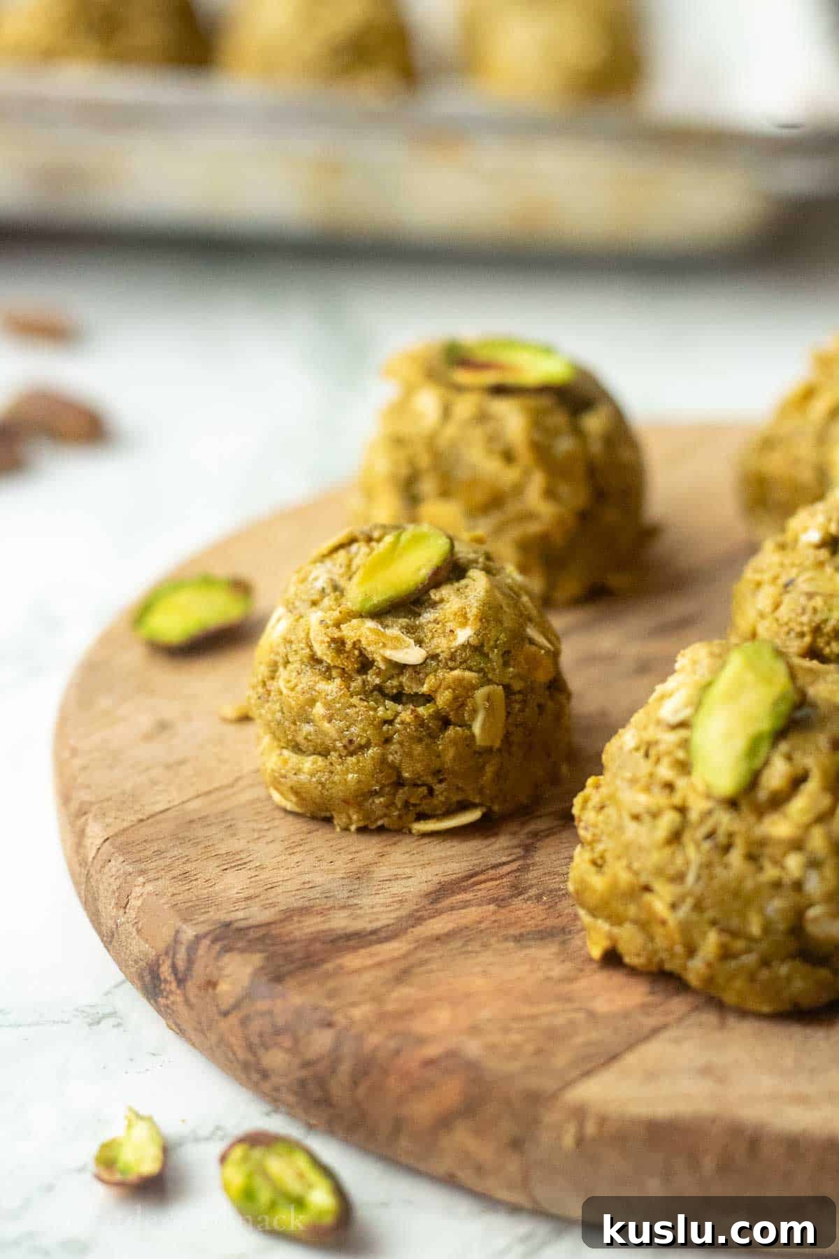 Pistachio Energy Protein Balls for Quick Snacks 2 Pistachio protein ball on wooden board.