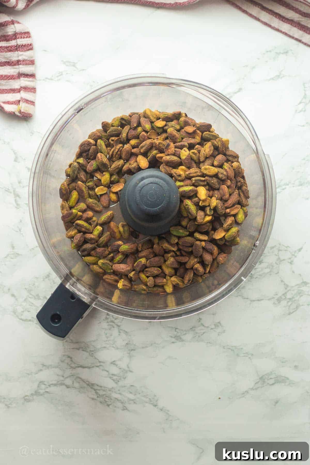 Pistachio Energy Protein Balls for Quick Snacks 4 Pistachios in bowl of food processor.