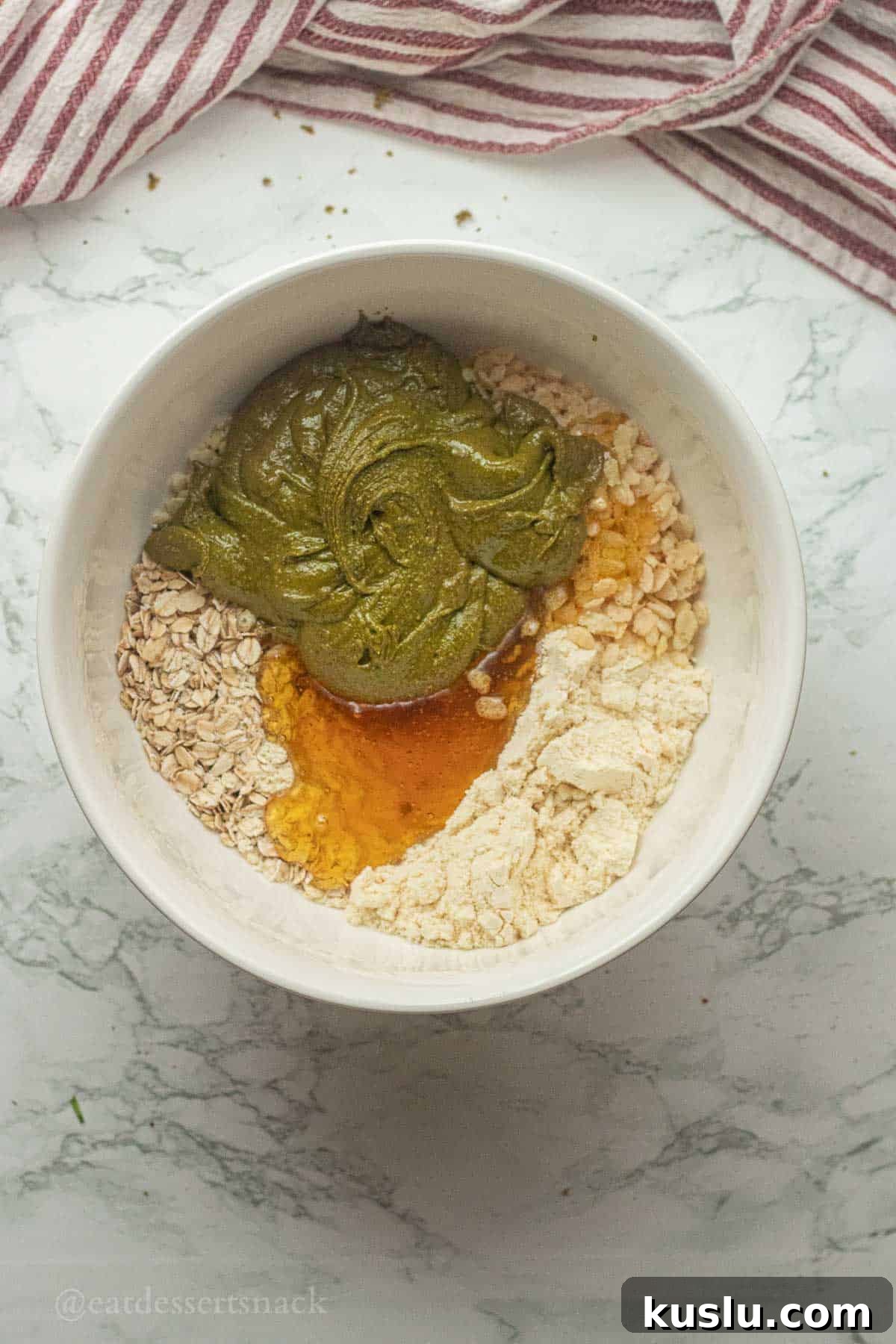 Pistachio Energy Protein Balls for Quick Snacks 6 Pistachio butter, honey, and dry ingredients in a bowl.