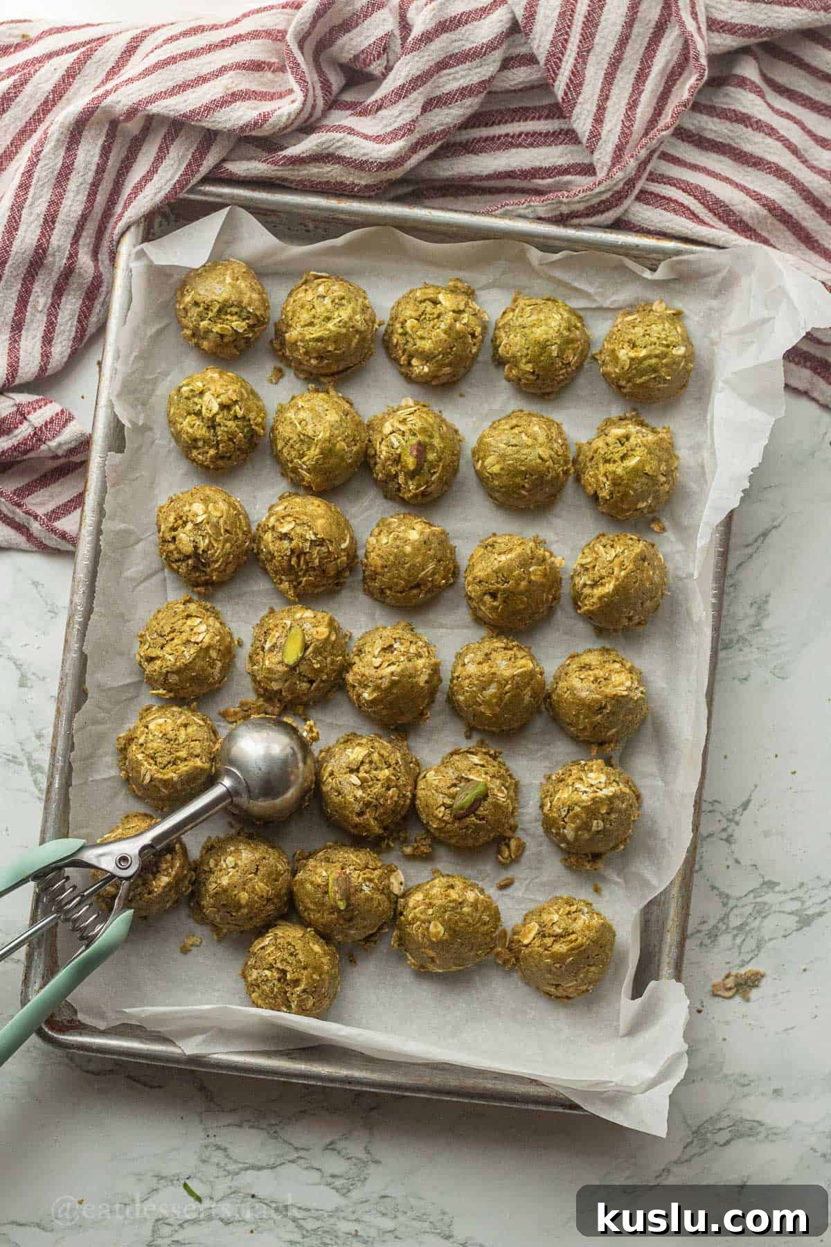 Pistachio Energy Protein Balls for Quick Snacks 7 Pistachio protein balls on metal pan.