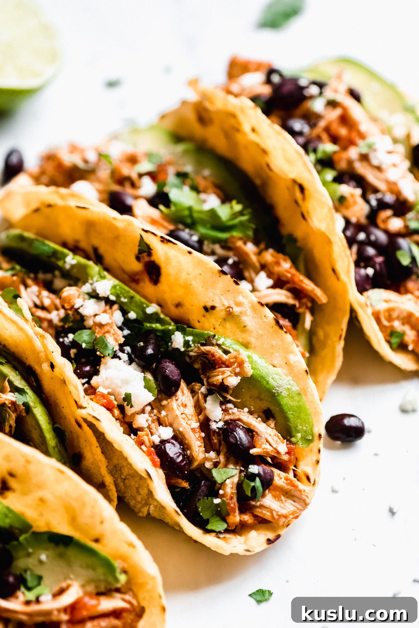 Assembled Salsa Chicken Tacos Slow Cooker Salsa Chicken Tacos filled with shredded salsa chicken, black beans, avocados, cilantro, and Queso fresco.