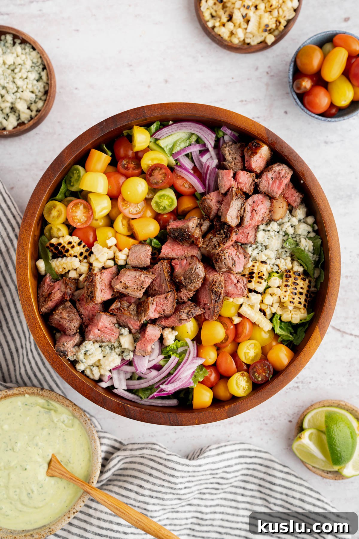 Grilled Steak Salad with Avocado-Lime Cilantro Crema 11 The finished steak salad in a bowl with the avocado lime crema off to the side.