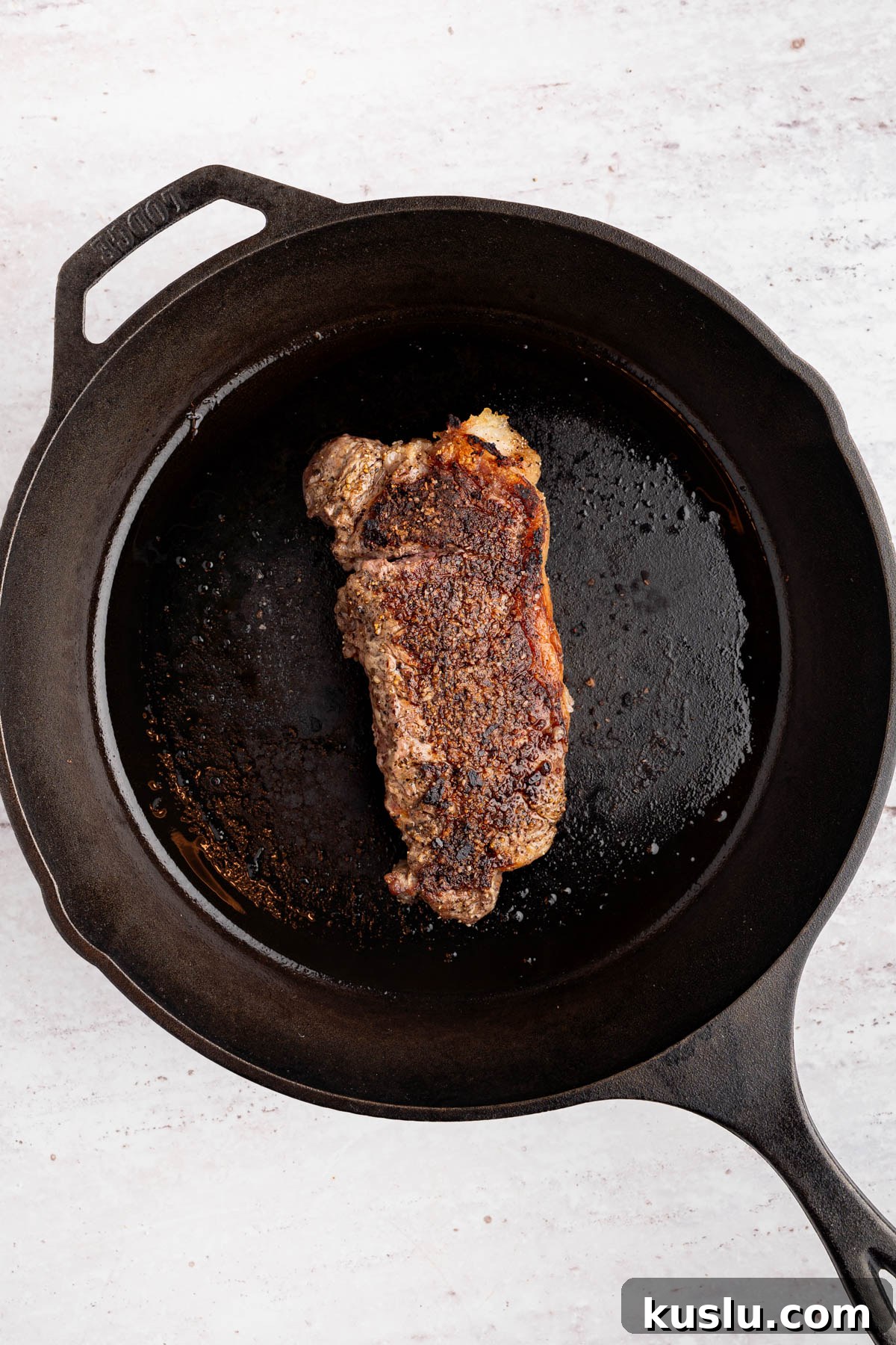Grilled Steak Salad with Avocado-Lime Cilantro Crema 5 The seared steak in a cast iron skillet.