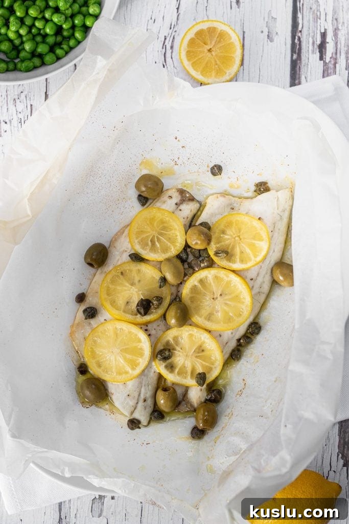 Sea bass with lemon slices, capers and olives
