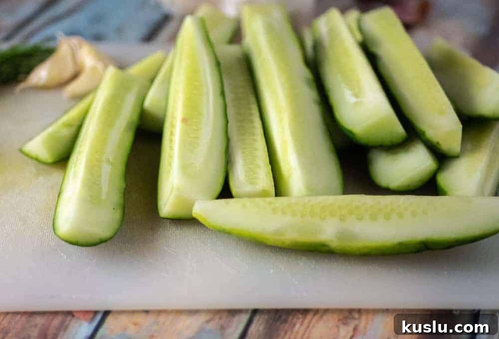Quick Refrigerator Pickles: Simple No-Cook Dill Recipe 4 Sliced cucumbers ready for refrigerator pickles - Freshly cut cucumber spears on a cutting board, prepped for a homemade dill pickle recipe with no canning required.