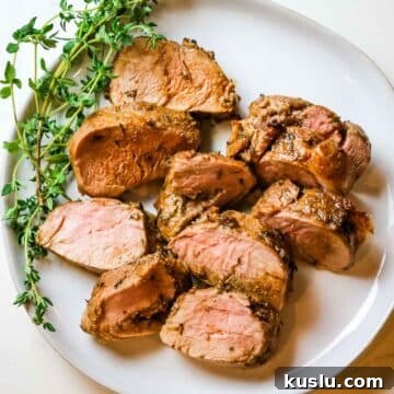 pork tenderloin medallions on a white plate.