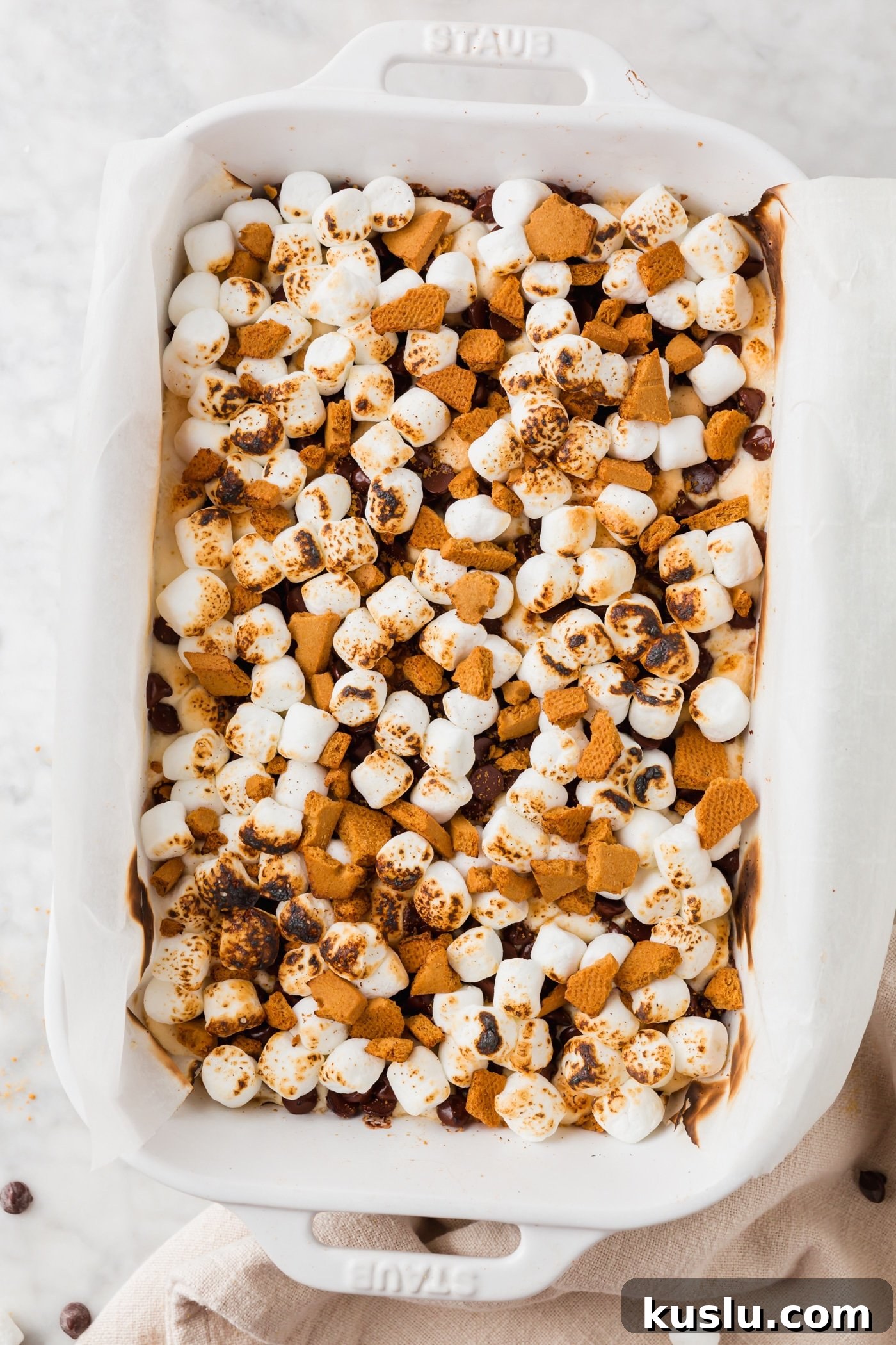 Gluten-Free S’mores Bars Recipe — Chewy Graham & Chocolate Squares 6 A baking dish filled with s'mores bars that have been toasted with a kitchen torch.