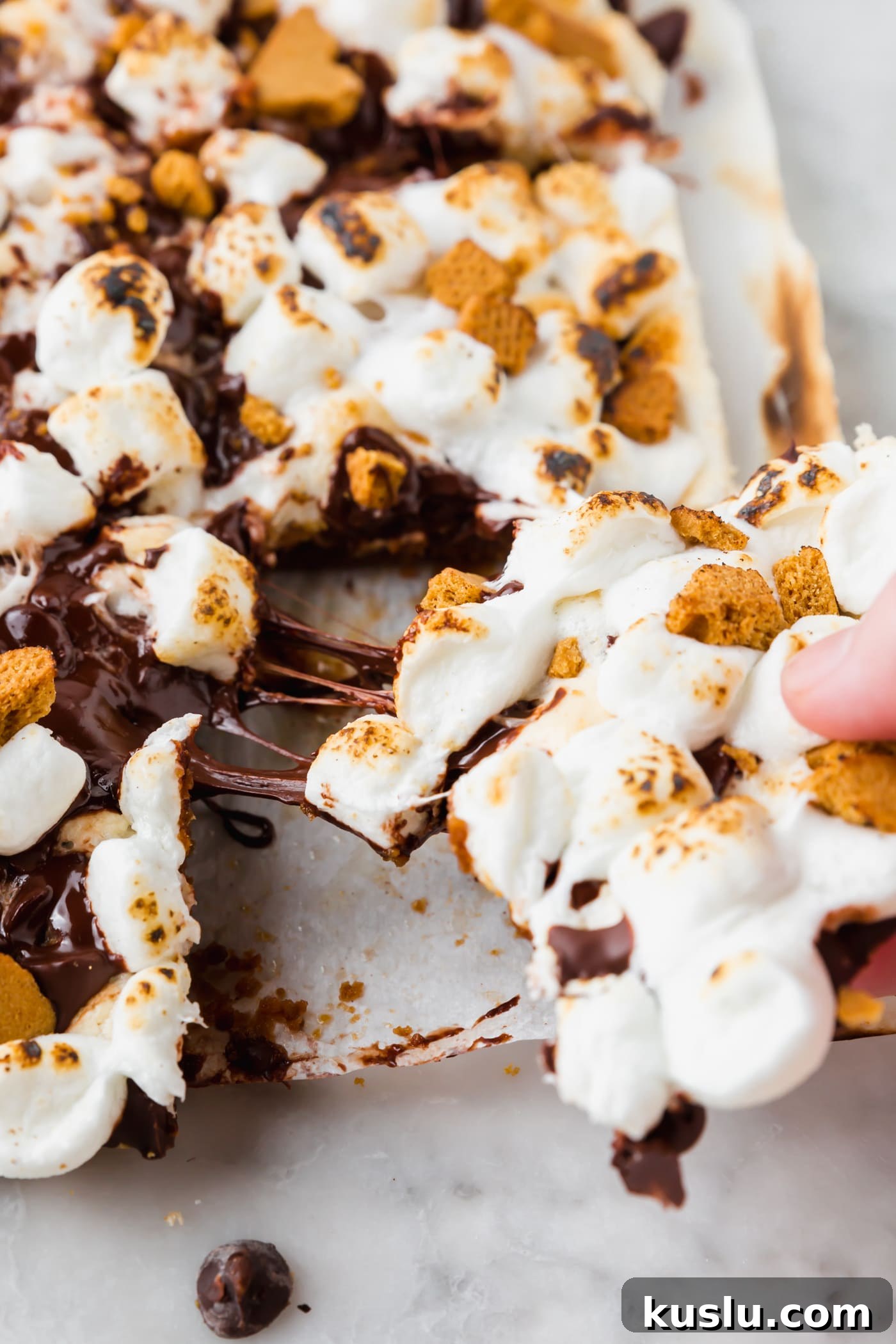 Gluten-Free S’mores Bars Recipe — Chewy Graham & Chocolate Squares 7 A slice of gluten-free s'mores bar being pulled out from the group.