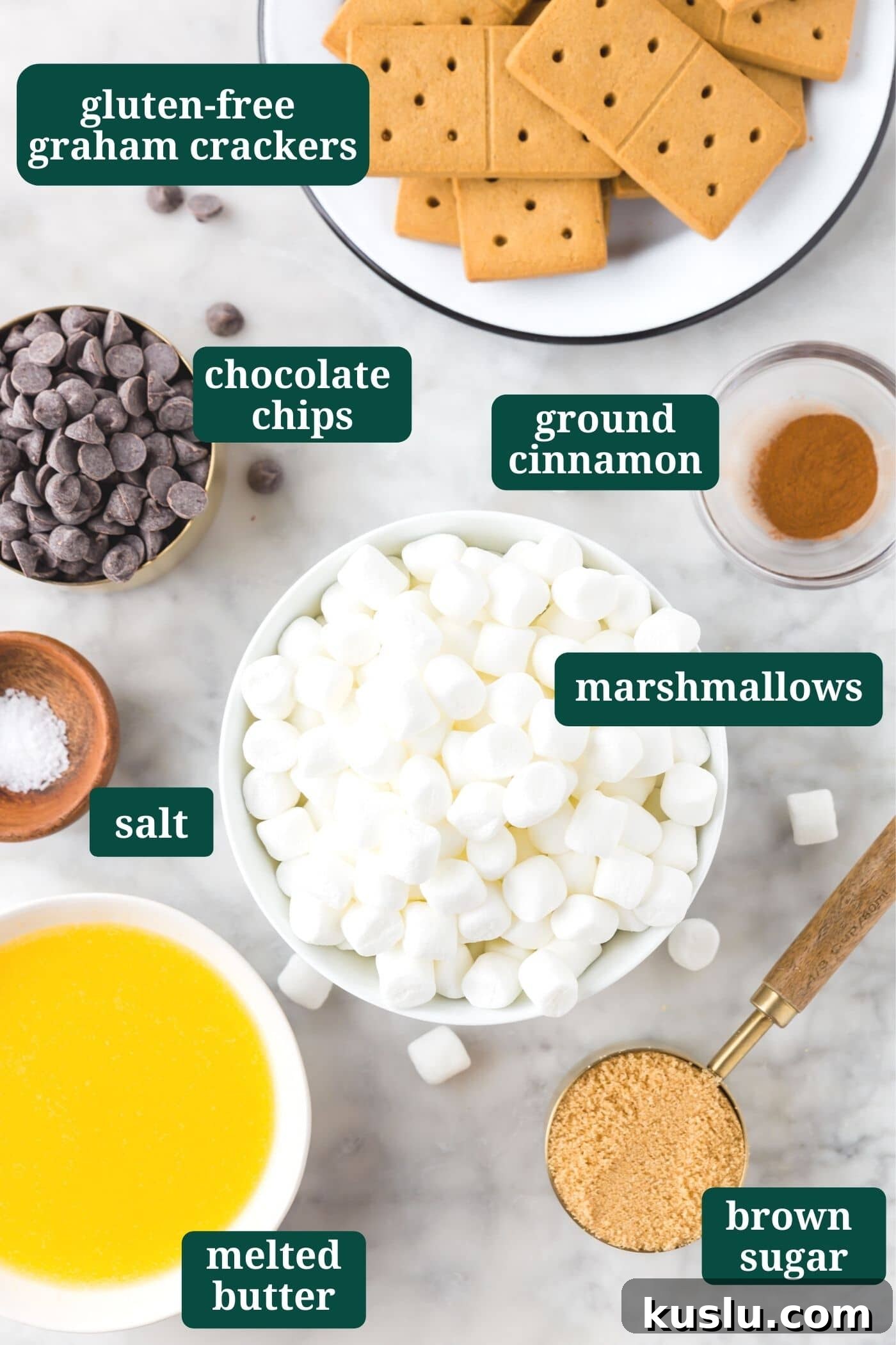 Gluten-Free S’mores Bars Recipe — Chewy Graham & Chocolate Squares 4 An overhead photo of ingredients for s'mores bars: gluten-free graham crackers, semi-sweet chocolate chips, mini marshmallows, ground cinnamon, salt, melted butter and brown sugar.