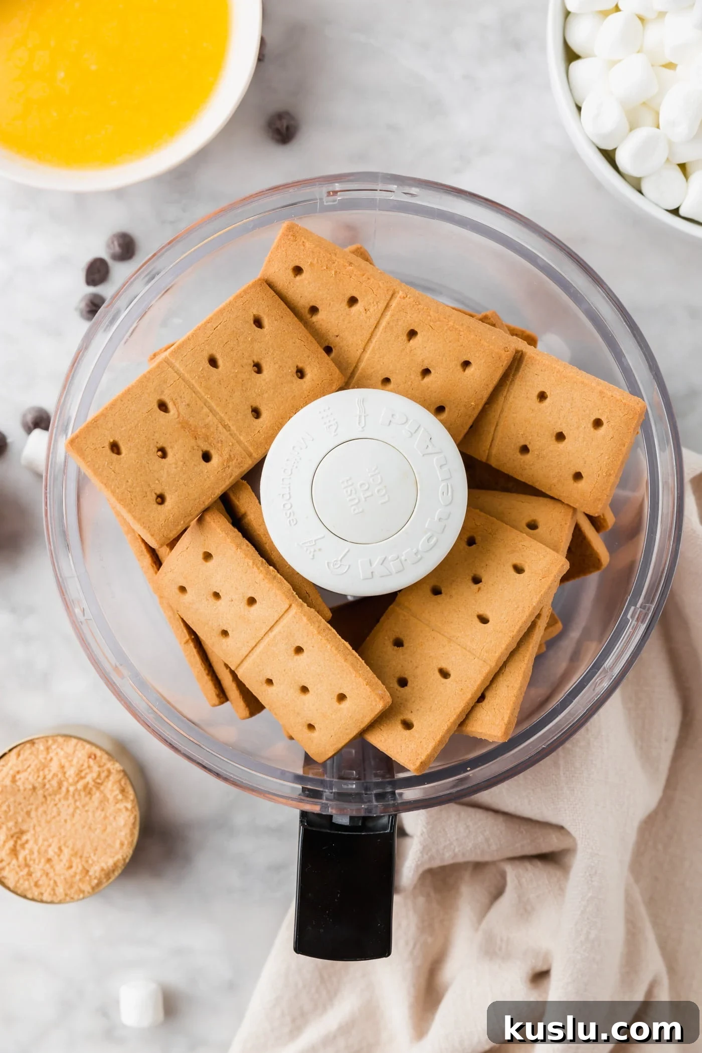 Gluten-Free S’mores Bars Recipe — Chewy Graham & Chocolate Squares 5 A food processor with gluten-free graham crackers in it.