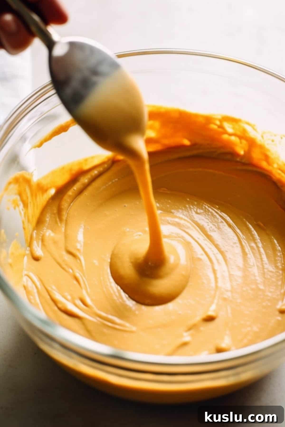 Pumpkin cheesecake batter in a bowl.
