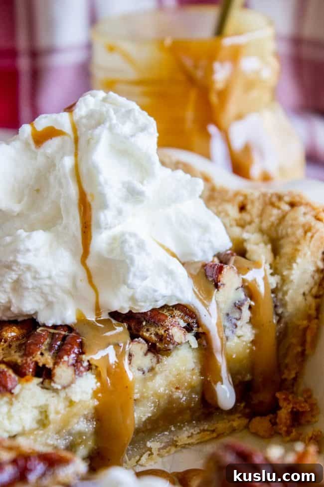 Pecan Pie Cheesecake Recipe – Creamy Layered Pecan Dessert 10 Slice of pecan pie cheesecake with whipped cream and caramel sauce.