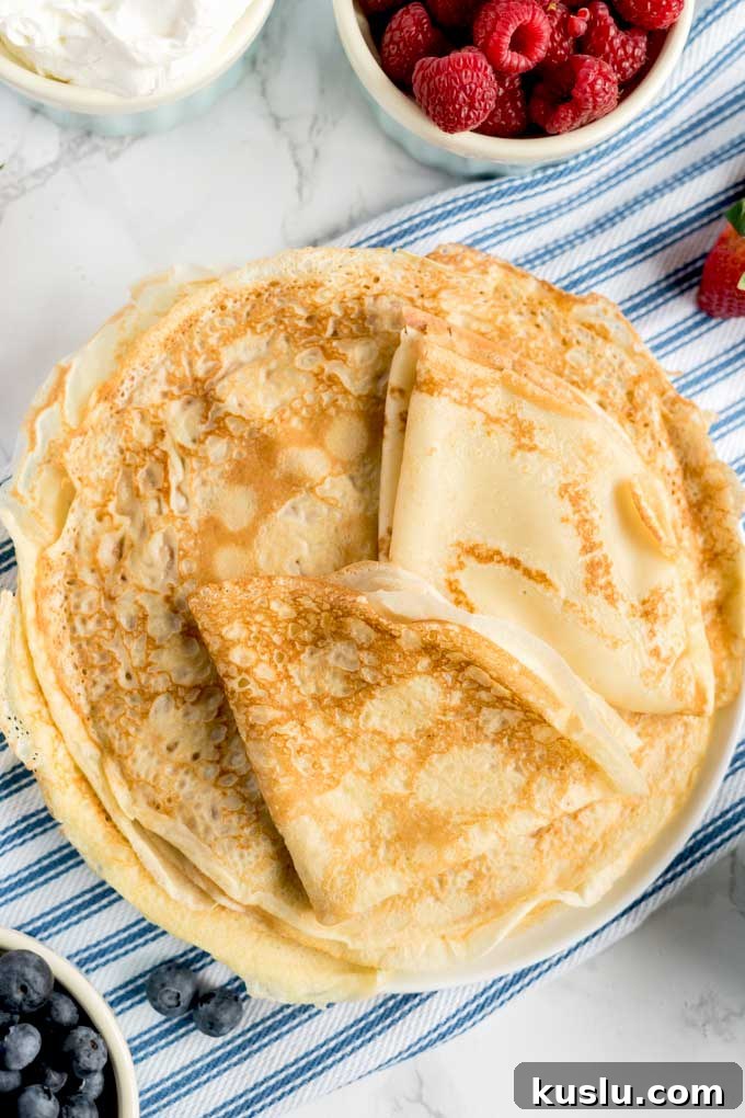 A plate piled up with easy to make crepes.