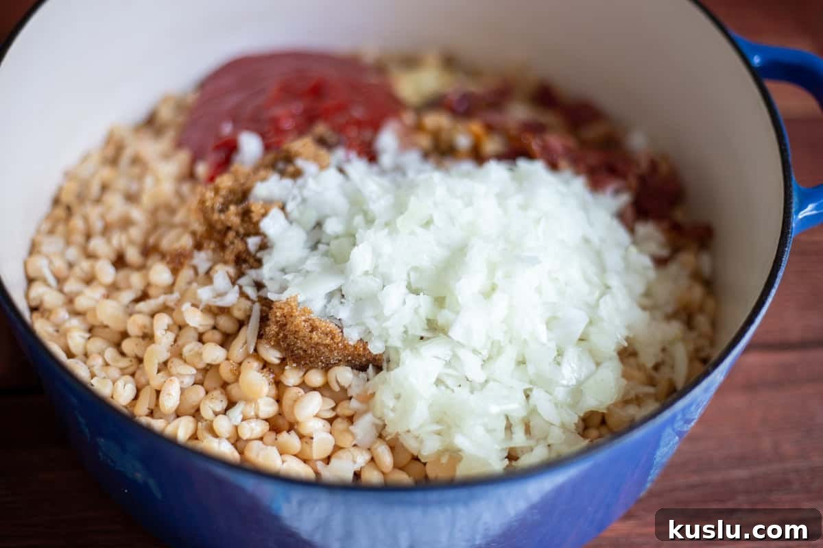 Scratch-Made Baked Beans Recipe for Rich, Slow-Cooked Flavor 5 All ingredients needed for recipe in blue Dutch oven.