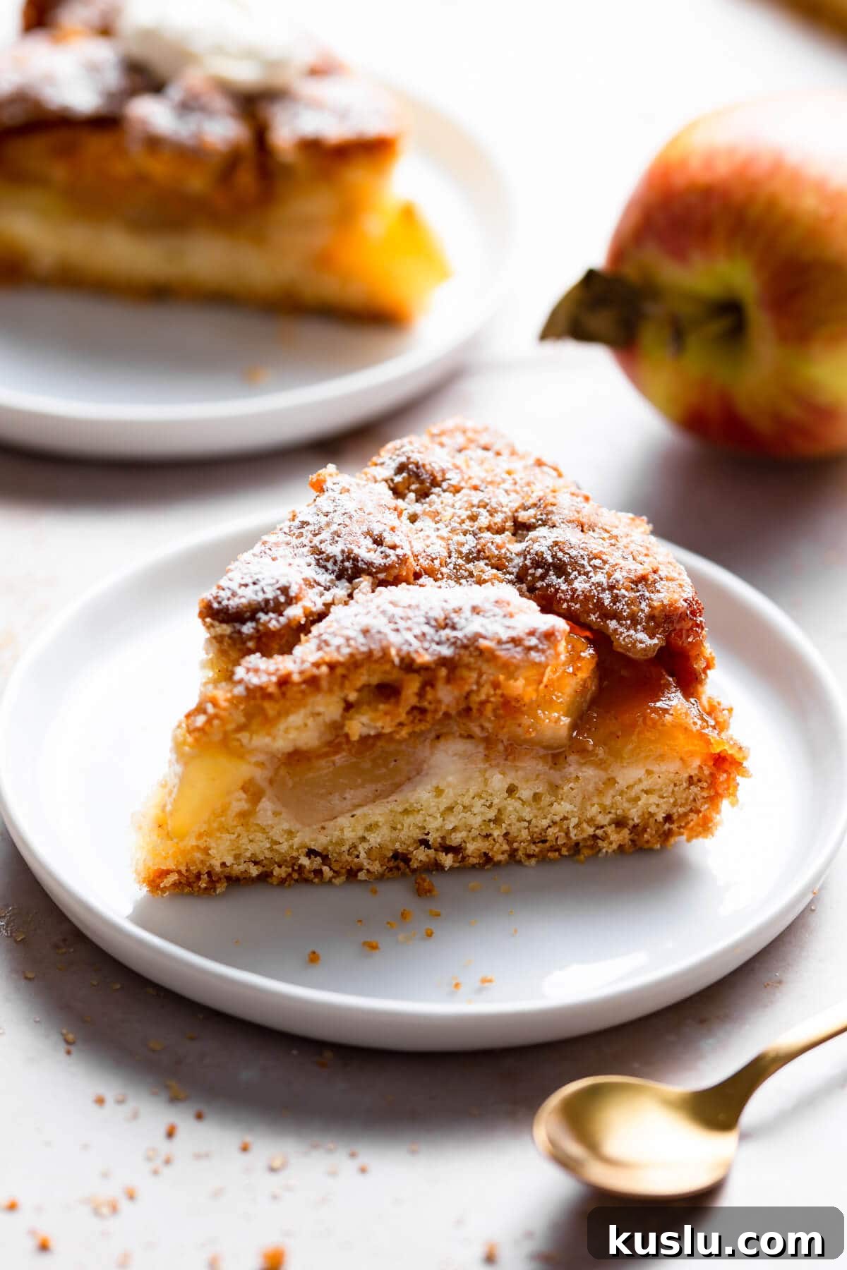 side super close up at an individual slice of an apple cake on a small plate