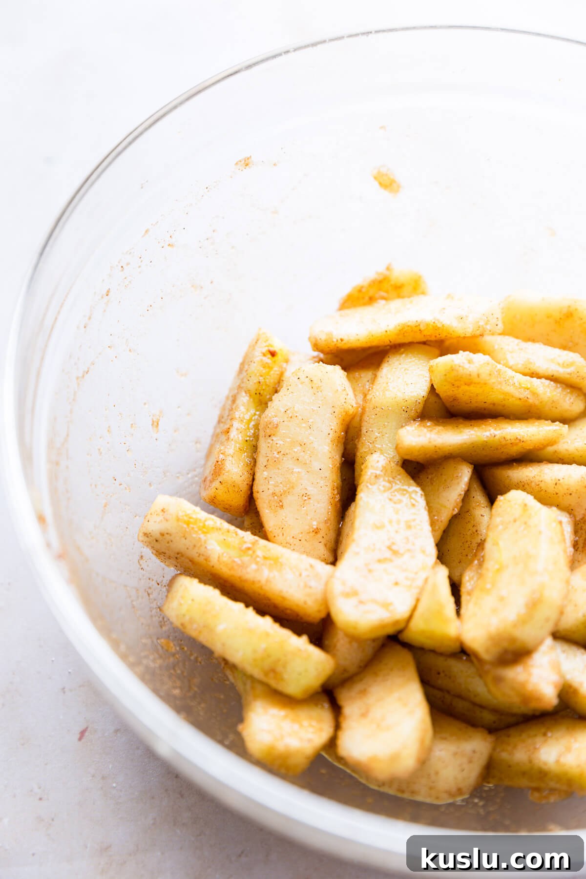 side super close up at sliced apples with sugar and cinnamon
