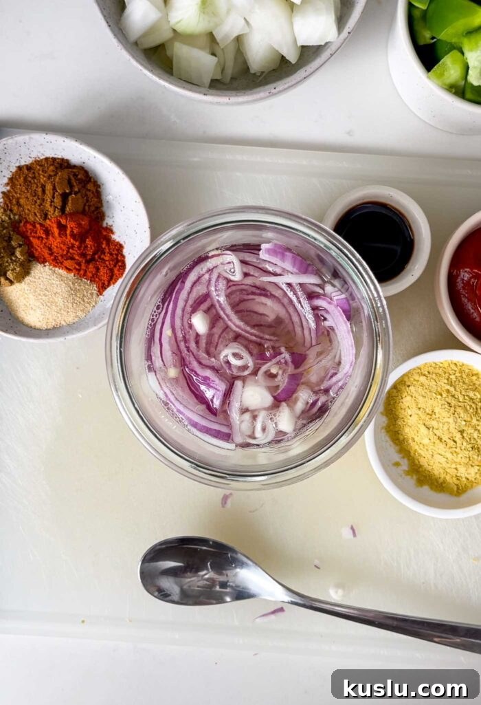 Jar of thinly sliced pickled red onions.