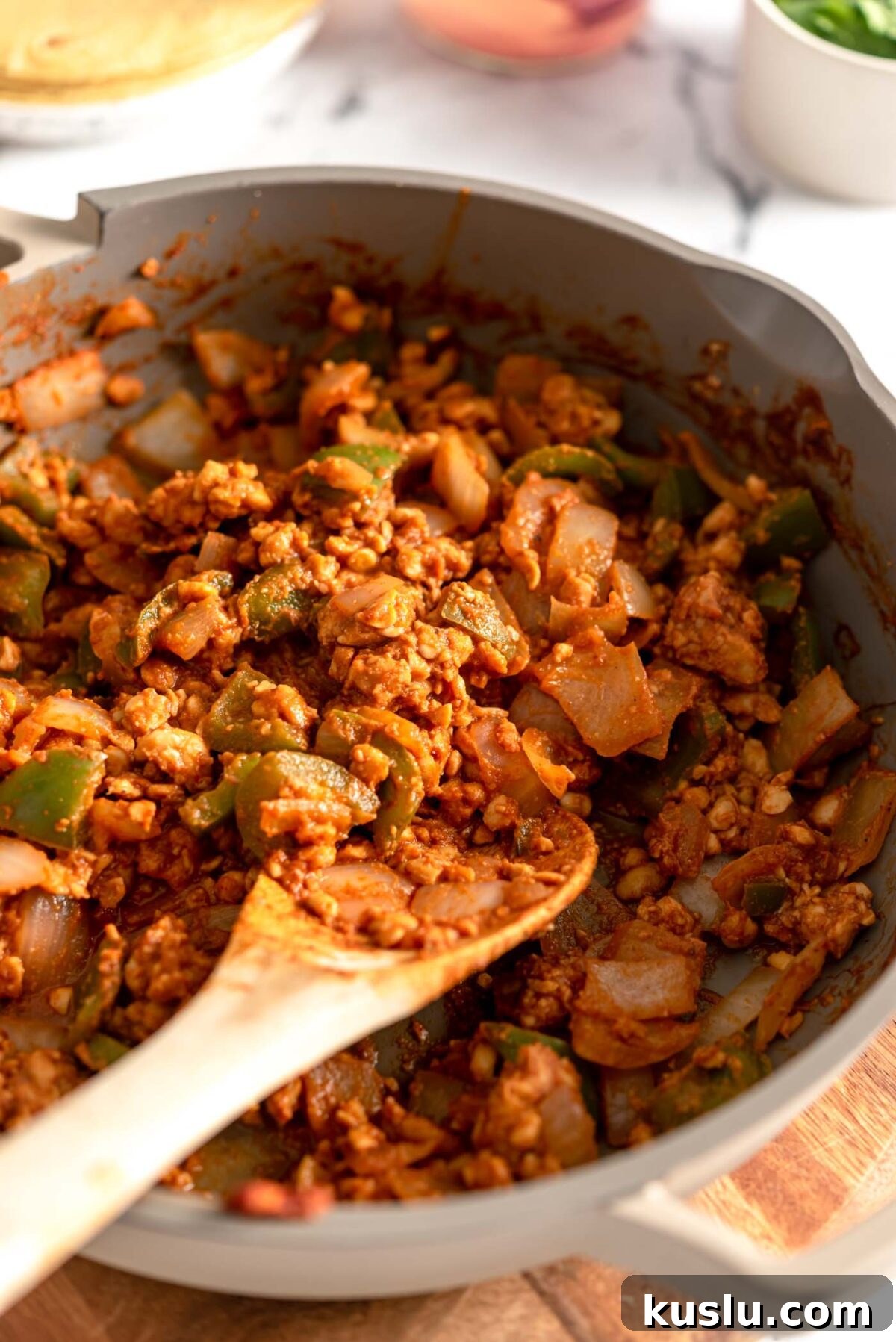 Crumbled tempeh cooked in taco seasonings in a pan.