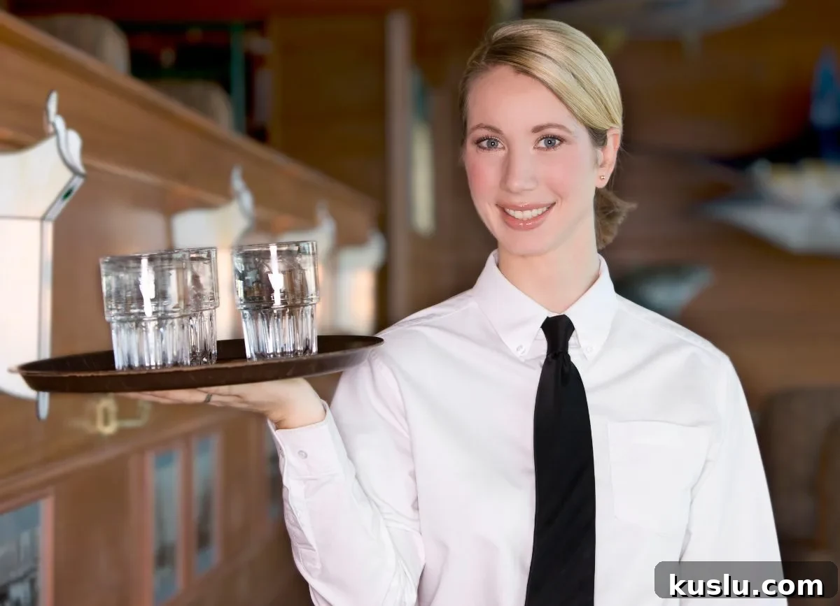 Gluten-Free & Dairy-Free Menu Options at The Cheesecake Factory 3 Server holding a tray of glasses.