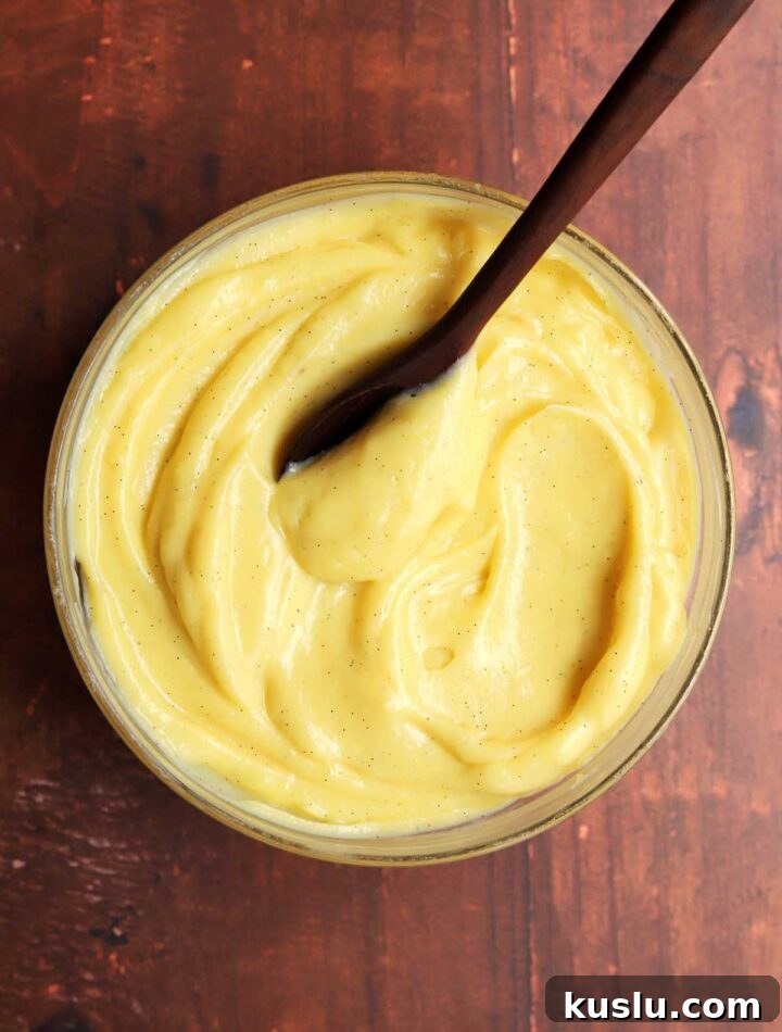 Homemade Vanilla Pastry Cream (Crème Pâtissière) Recipe 8 vanilla pastry cream in a bowl with spoon