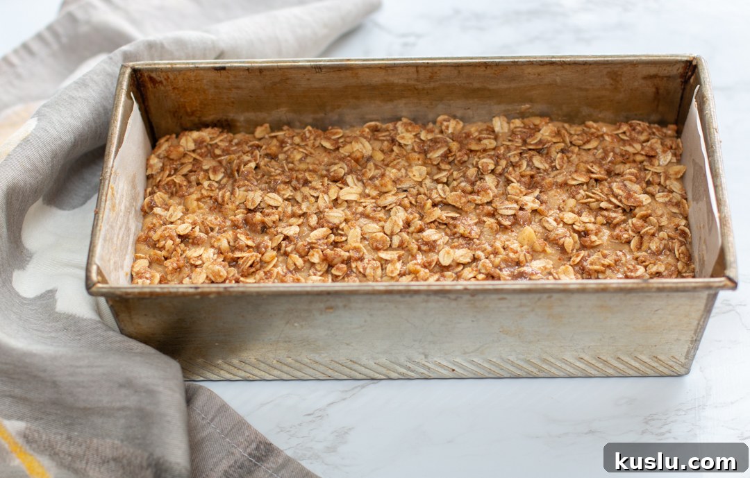 Ready to bake the applesauce loaf cake! The oat-streusel topping on top is gently pressed in
