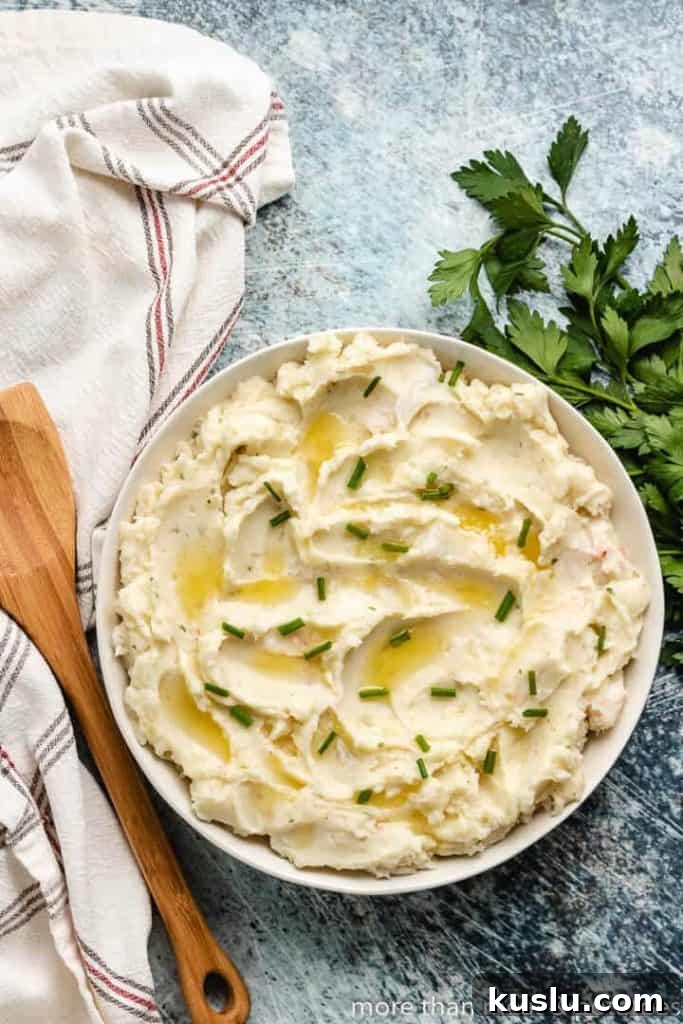 Creamy Lobster Mashed Potatoes Recipe for Dinner Guests 3 An aerial view of the potatoes topped with butter and chives.