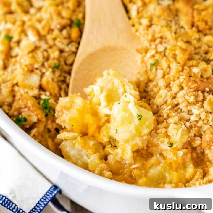 Creamy Lobster Mashed Potatoes Recipe for Dinner Guests 7 Close up view of a spoon scooping fruit casserole.